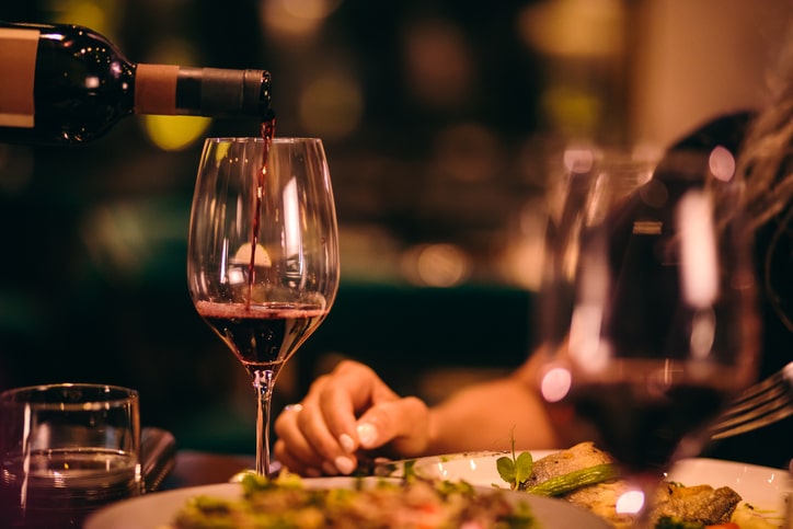 Types of Liquor Licenses: Food Primeary/Class A. Image: Wine being poured at dinner on a restaurant